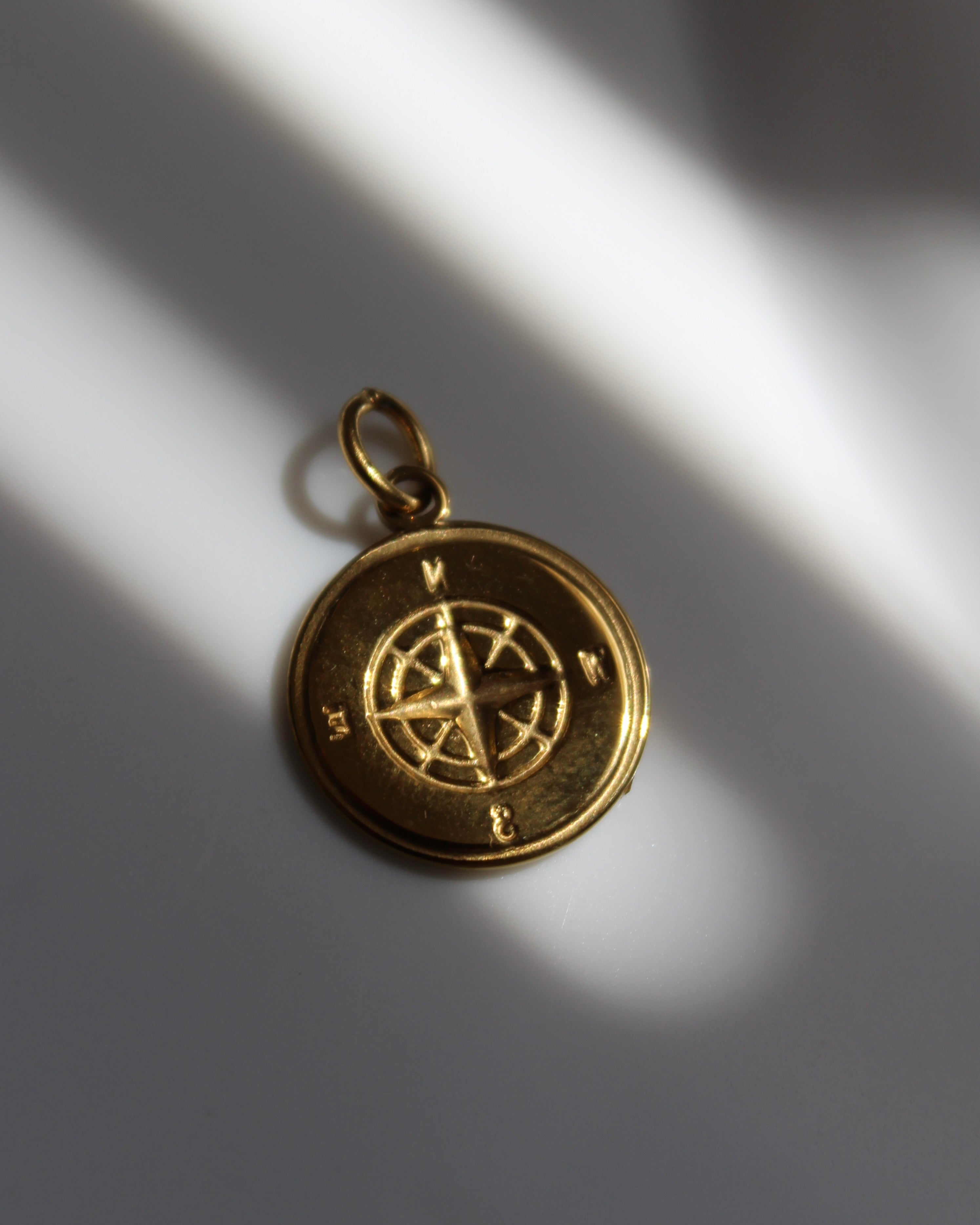 Gold Compass Charm.