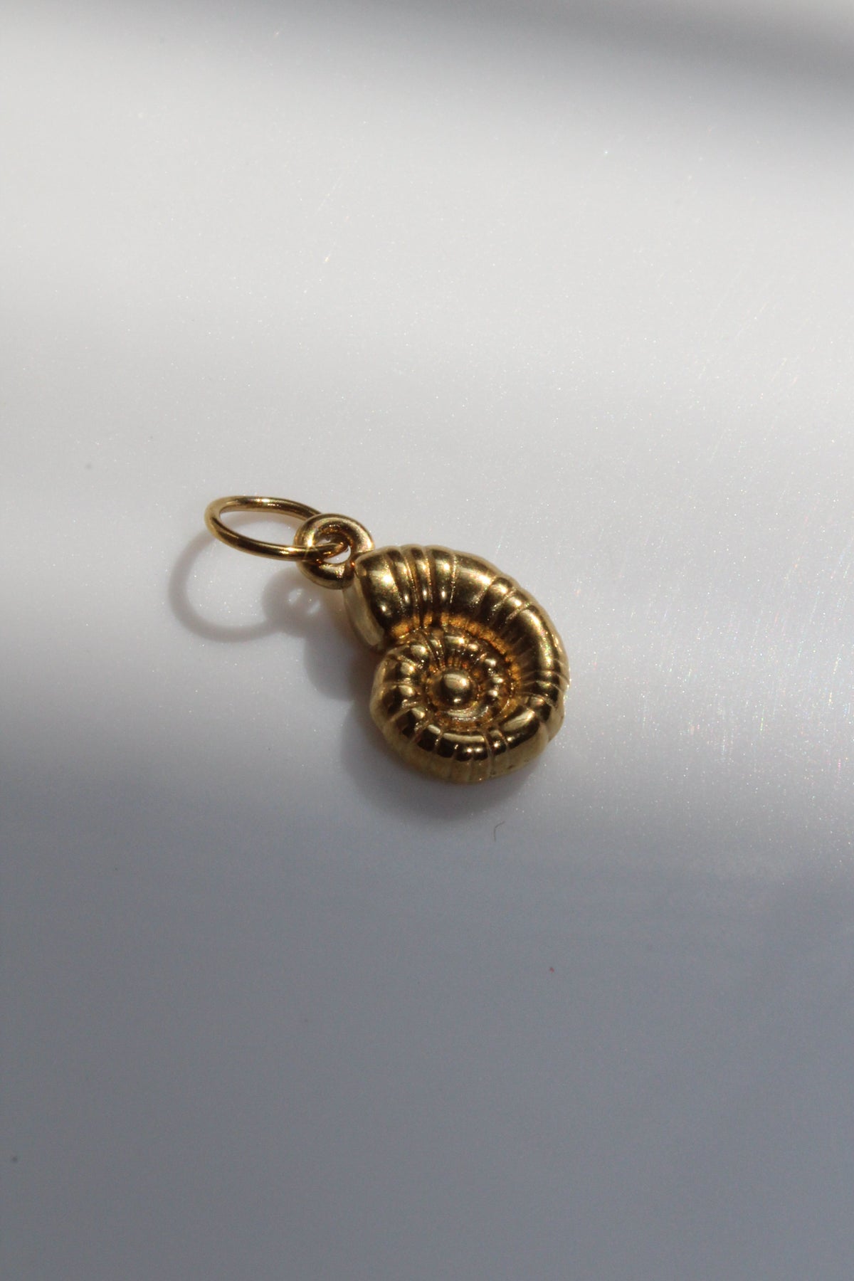 Gold Spiral Shell Charm.