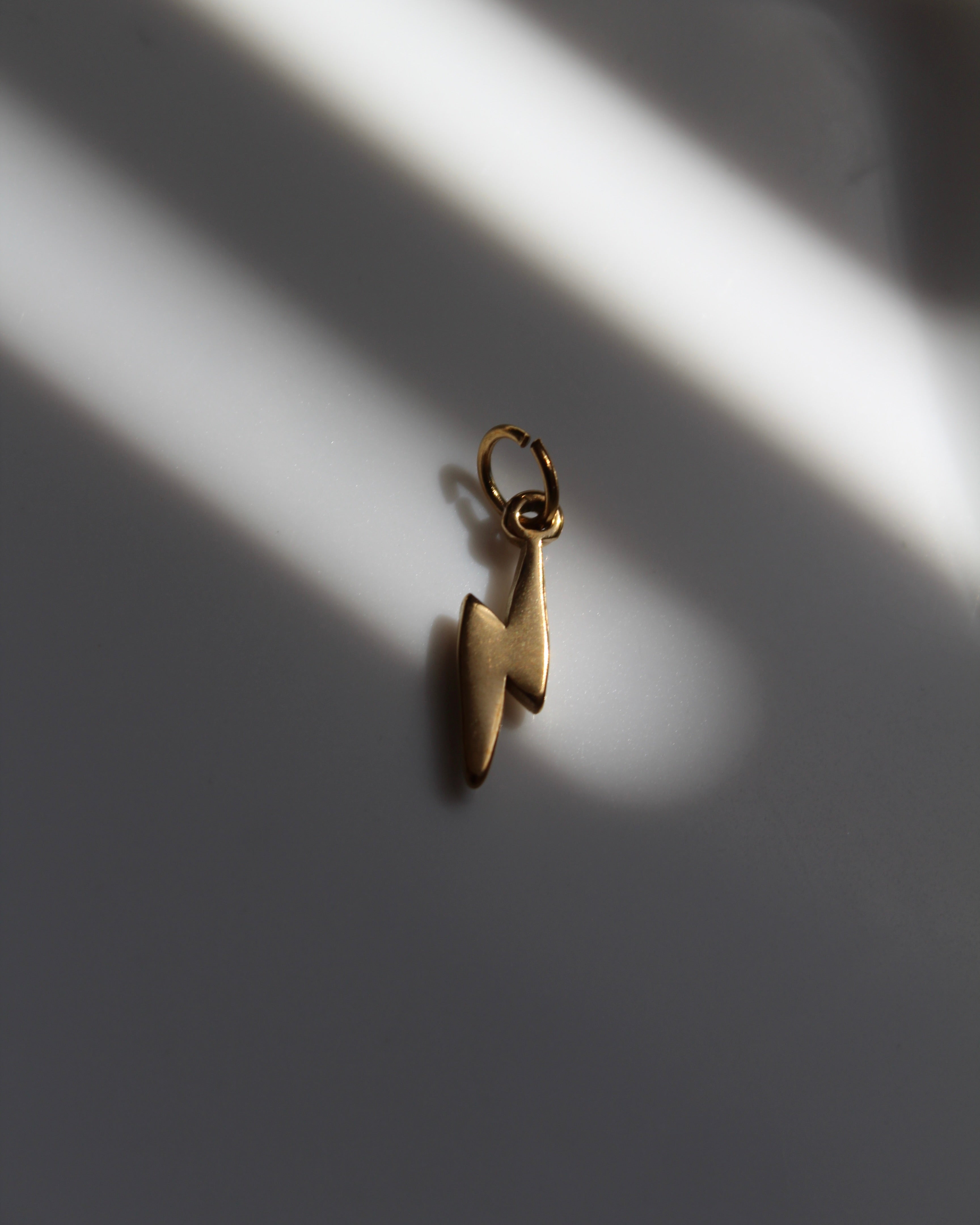 Gold Lightning Bolt Charm.